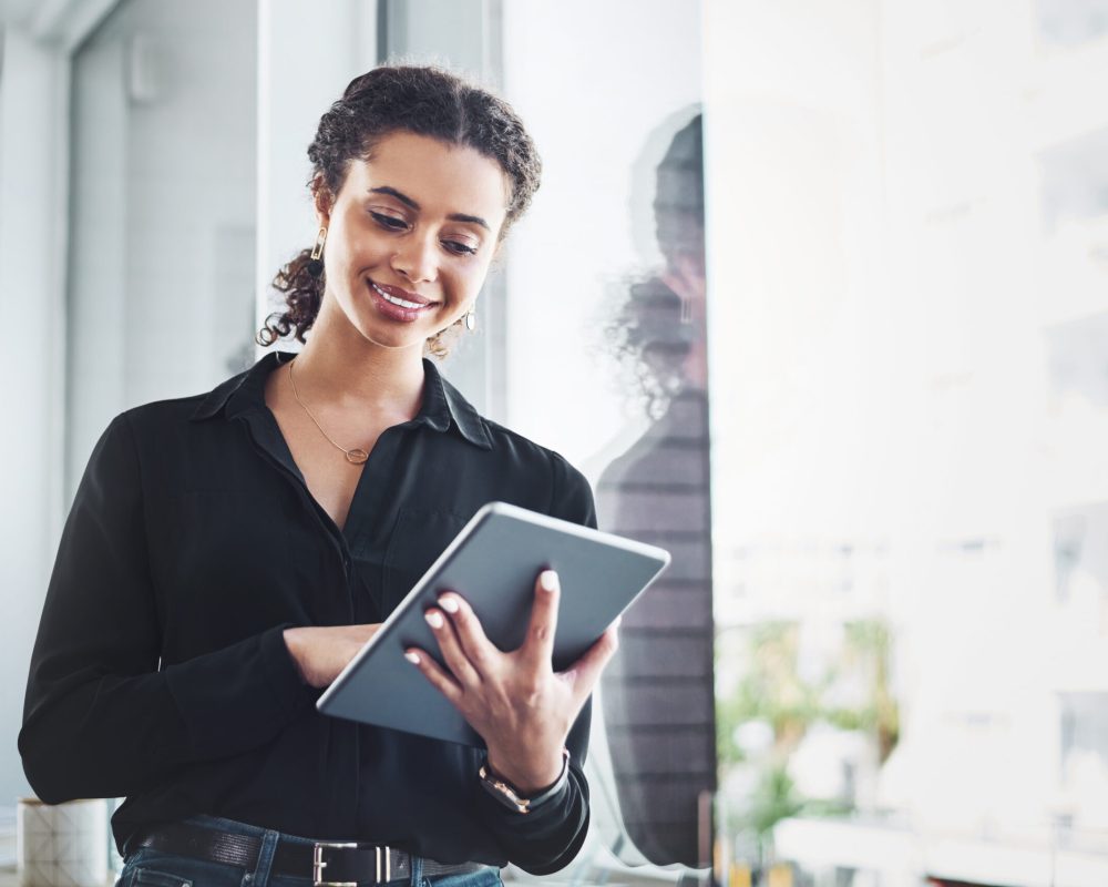 Shot of a young businesswoman using a digital tablet in an office.